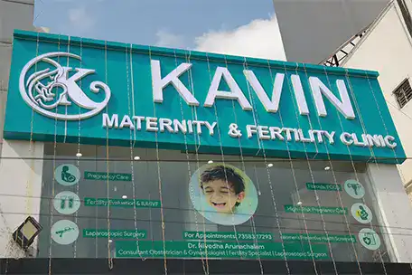 Kavin Maternity and Fertility Clinic sign with logo and contact info.